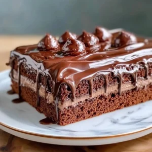 Delicious Chocolate Three Milks Cake topped with whipped cream and chocolate shavings.