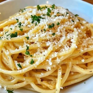 Plate of creamy garlic butter noodles garnished with herbs and spices
